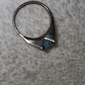 Silver ring, with single blue aquamarine stone.
